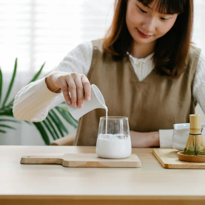 Calcium nutrition with milk poured into glass